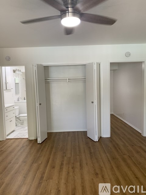 A kitchen with white cabinets and a white fridge.