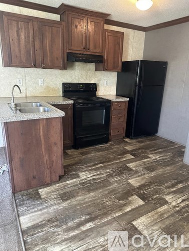 A kitchen with wooden cabinets and black appliances.