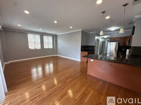 A kitchen with wooden floors and stainless steel appliances.
