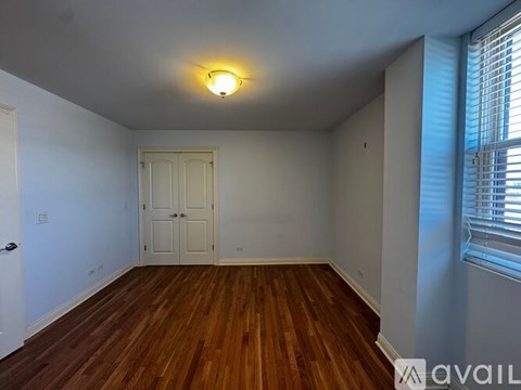 A kitchen with wooden floors and a refrigerator.
