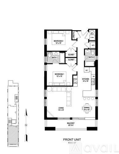 A spacious room with wooden flooring and a bar area in the corner.