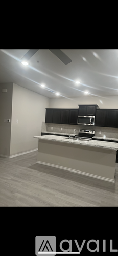 A modern kitchen with a stove top oven and a range hood.