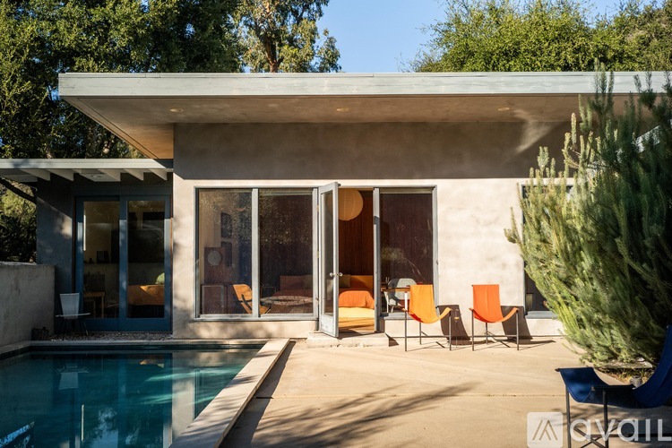 A modern house with a pool in the backyard.