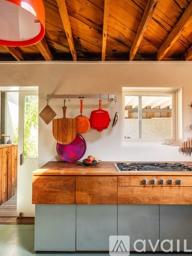 A kitchen with a wooden hanging pot rack.