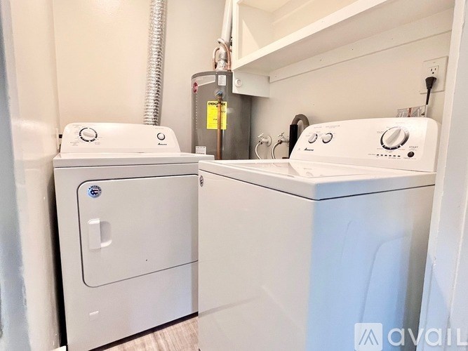 A white washing machine and dryer are available for use.