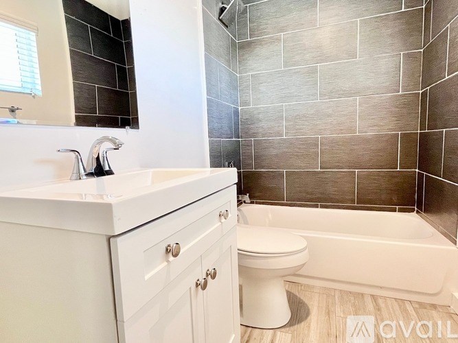A bathroom with a white toilet and a white sink.