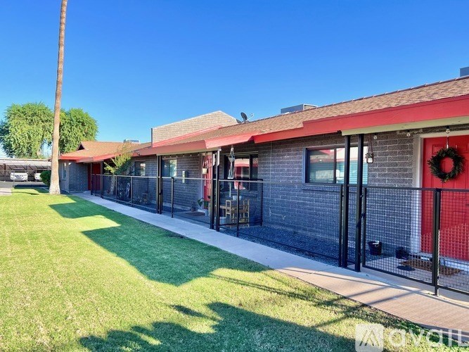 A building with a red door and a wreath on it.