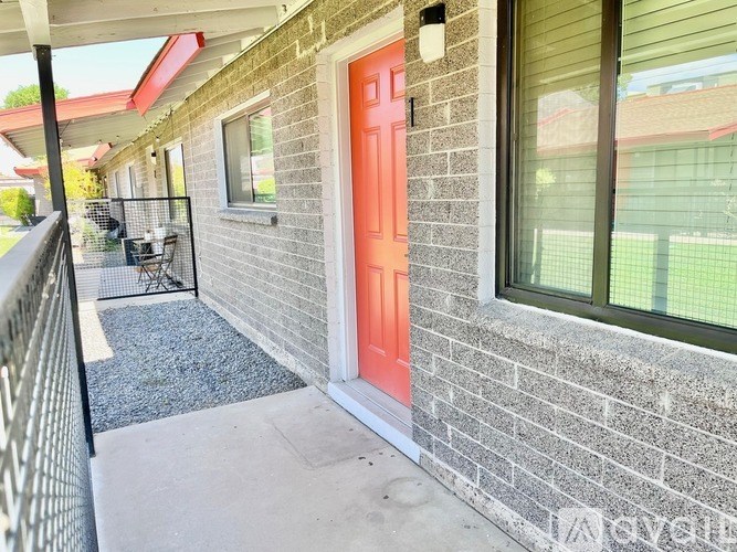 A red door is on the side of a house.