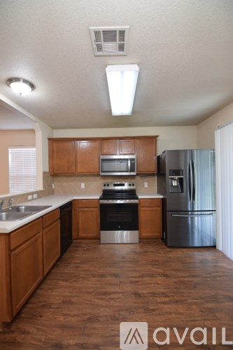 A kitchen area with a sink and a chandelier.