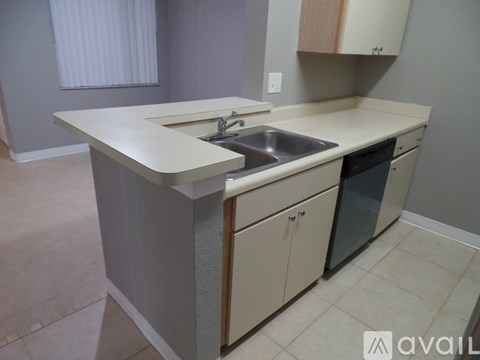 A kitchen with a sink and a dishwasher.