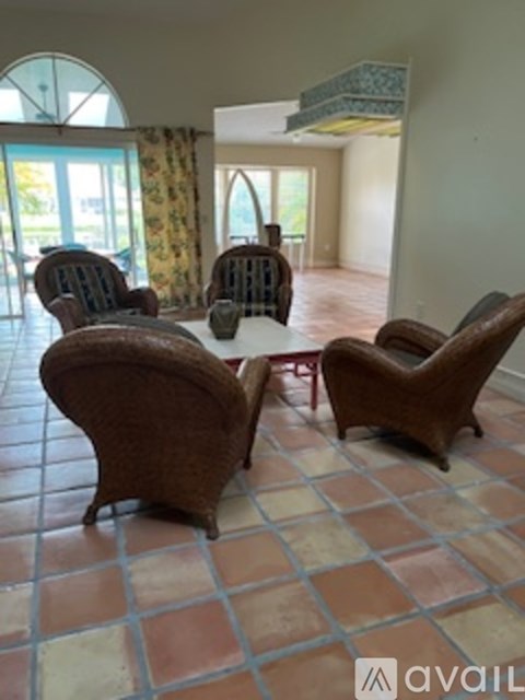 A living room with a table and chairs.