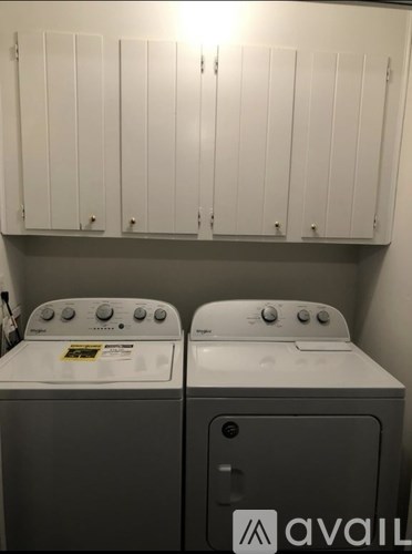 Two front loading washing machines in a laundry room.