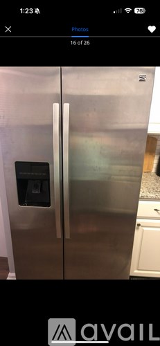 A stainless steel refrigerator with a water dispenser on the door.