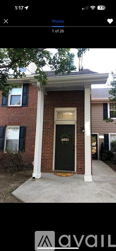A house with a black front door and a brick facade.