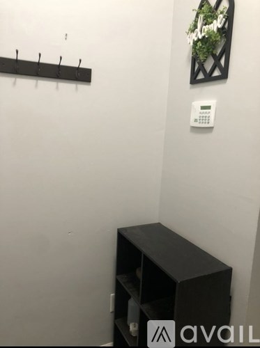 A wall mounted coat rack with a sign that says "Indoor".