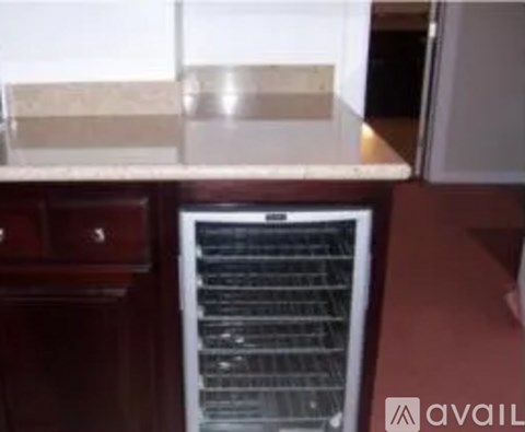 A kitchen with a white counter top and a white fridge.