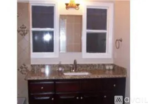 A bathroom with a sink and a window.