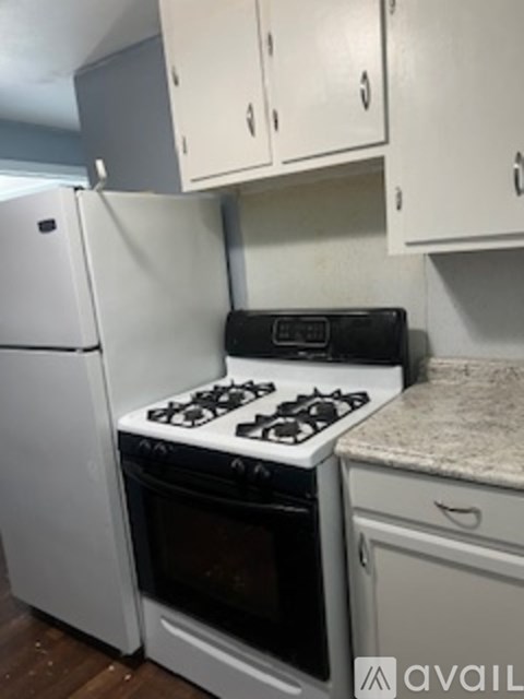A white oven and stove top are in a kitchen.