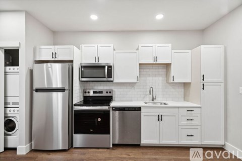 A kitchen with white cabinets and stainless steel appliances.