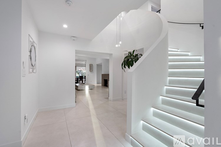 A modern living room with a grey sofa and a fireplace.
