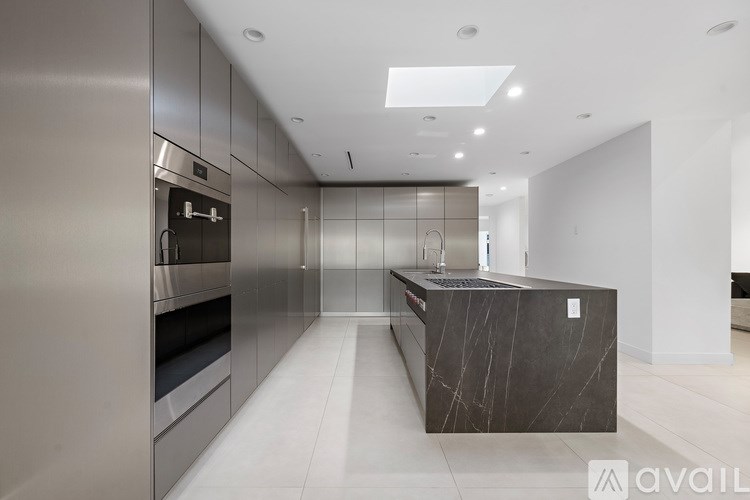 A spiral staircase with a black railing and white steps.