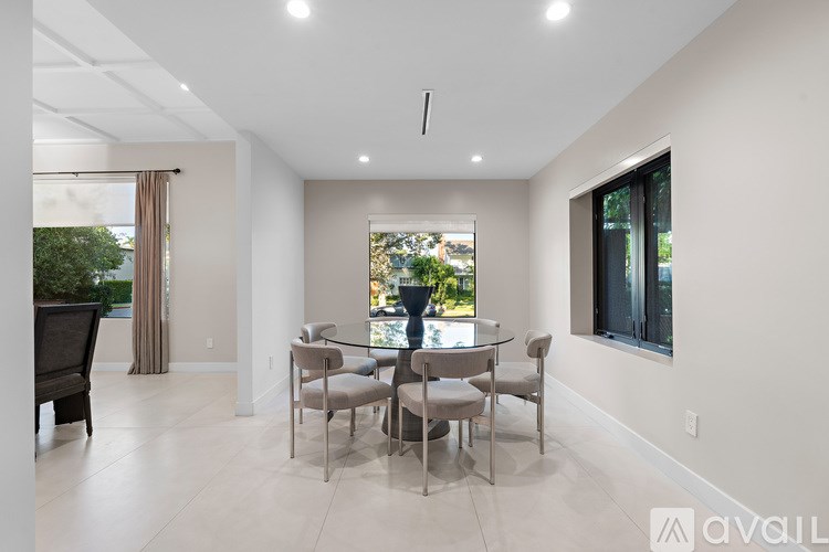 A white staircase with a black handrail.