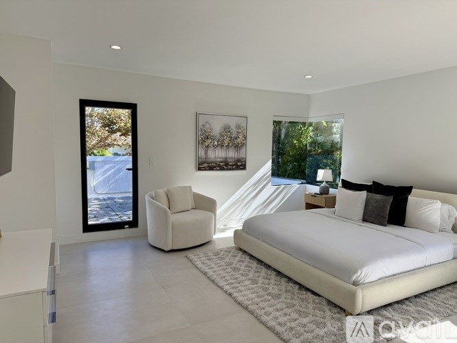 A glass table surrounded by chairs in a room.