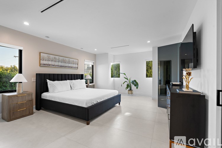 A swimming pool surrounded by trees and a concrete wall.