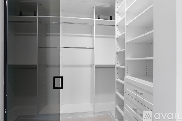 A white walk-in closet with shelves and drawers.