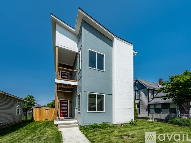 A modern two-story house with a blue exterior and white trim.