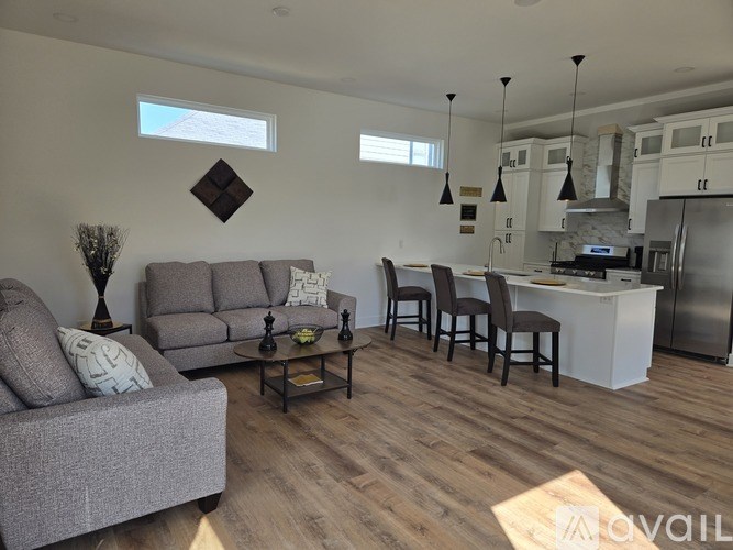 A bathroom with a white countertop and a round mirror.