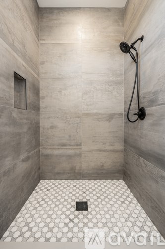 A bathroom with a shower and a tiled floor.