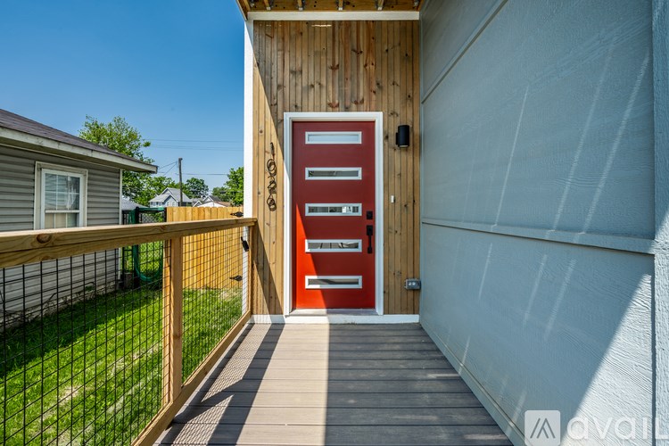 A red door is on the side of a building.