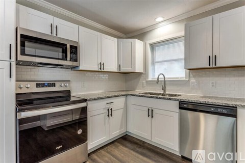 A kitchen with white cabinets and stainless steel appliances.