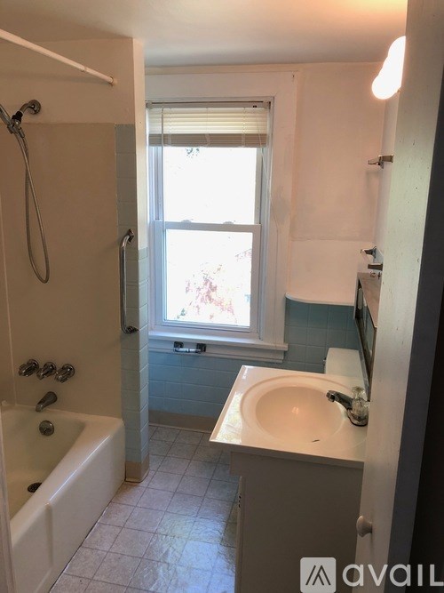 A bathroom with a white tub and sink.