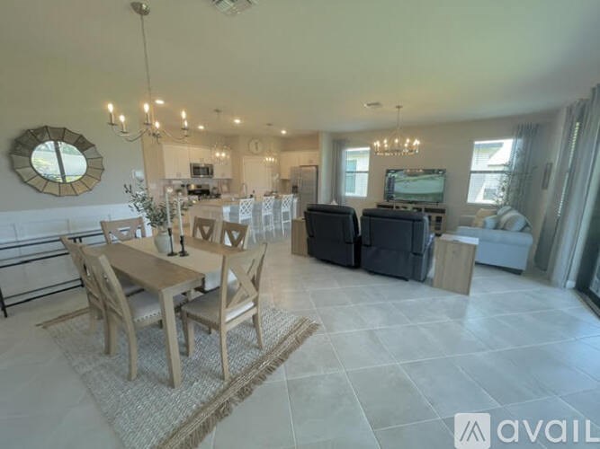 A living room with a dining table and chairs in the foreground.