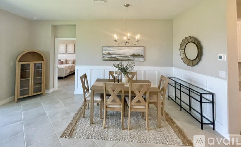 A dining room with a table set for six.