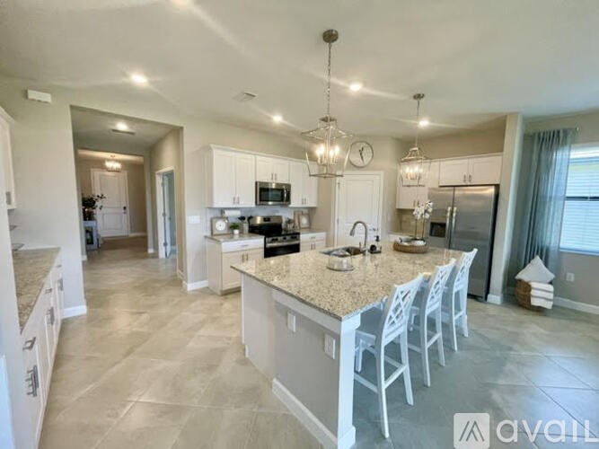 A spacious kitchen with a central island and modern appliances.