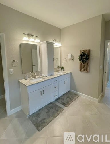 A bathroom with a vanity and a mirror.