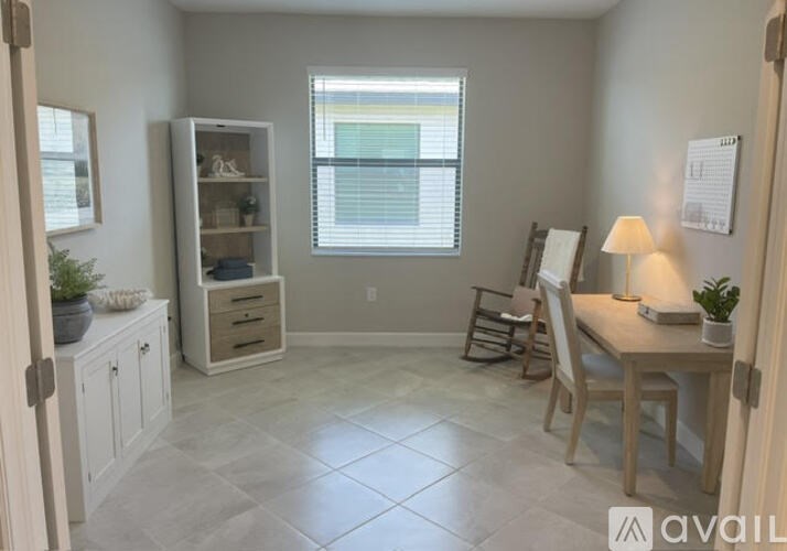 A room with a desk, chair, and a cabinet with shelves.
