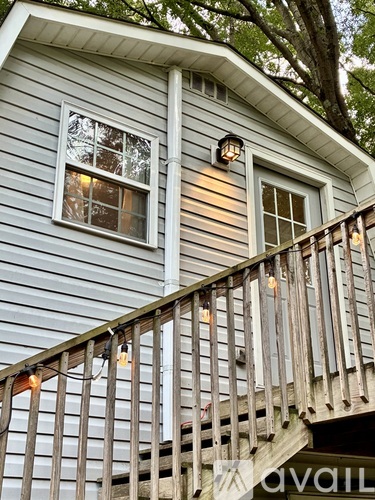 A house with a grey siding and a white window.