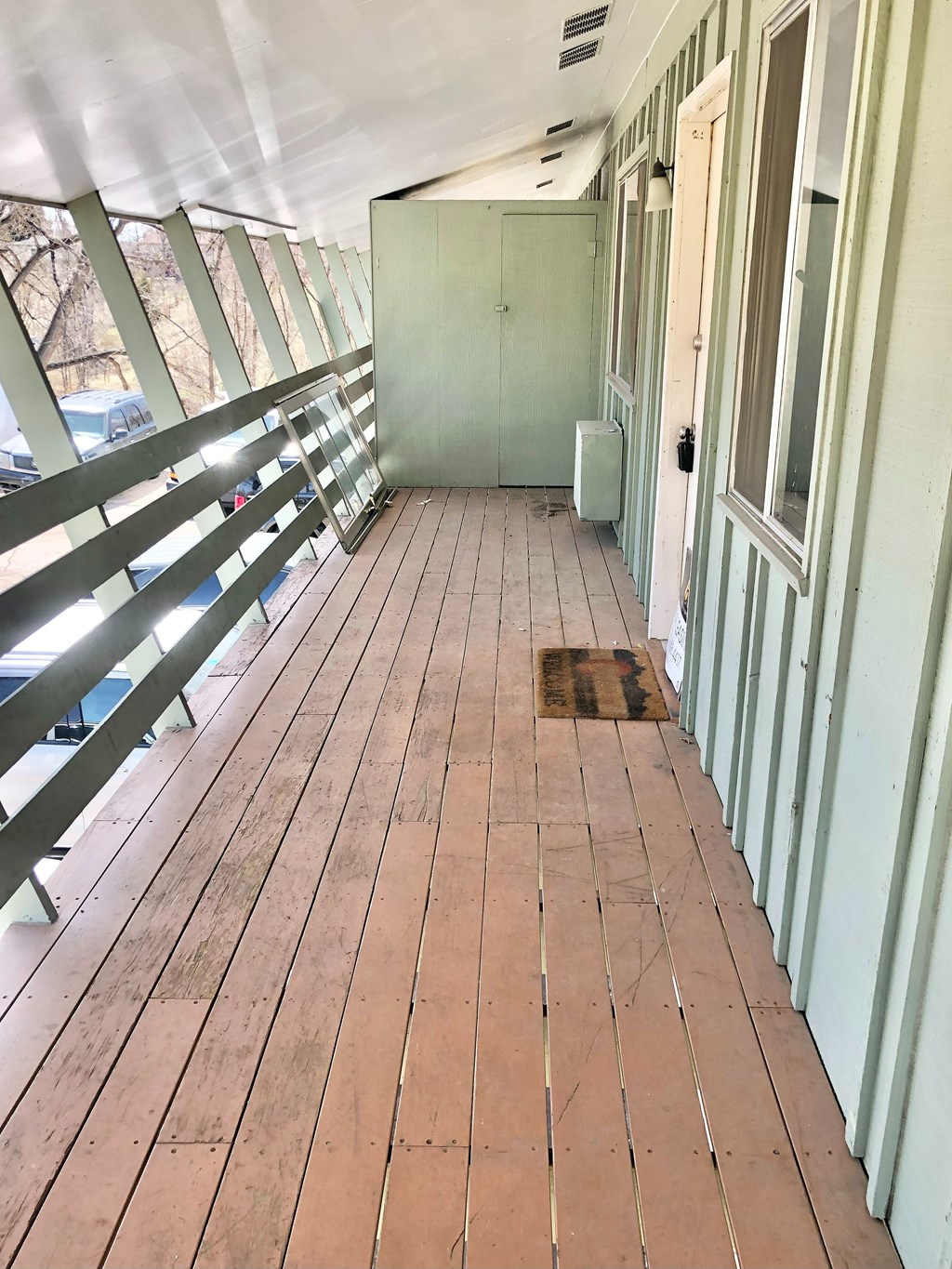 A long wooden deck with a metal railing.