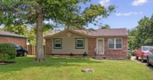 A house with a tree in front of it.