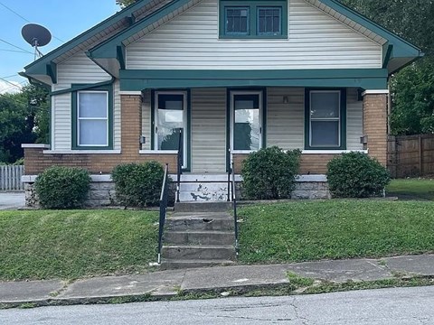 A house with a green door and windows.