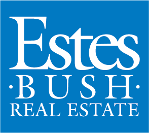 A blue sign with the words Estes Bush Real Estate in white.