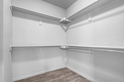 A white room with a wooden floor and white walls.