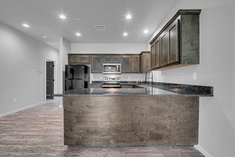 A kitchen with a large island in the middle.