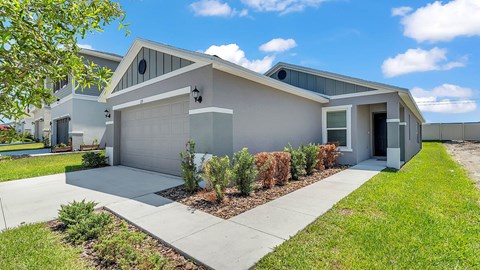 A modern house with a grey exterior and a white garage door.