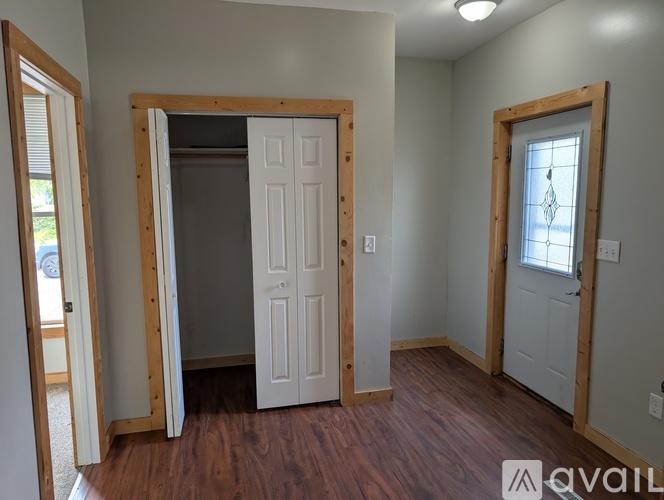 A room with a white door and wooden framing is available for rent.