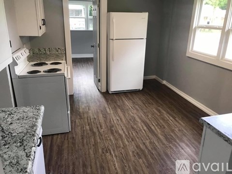 A kitchen with a white fridge and a white stove top.